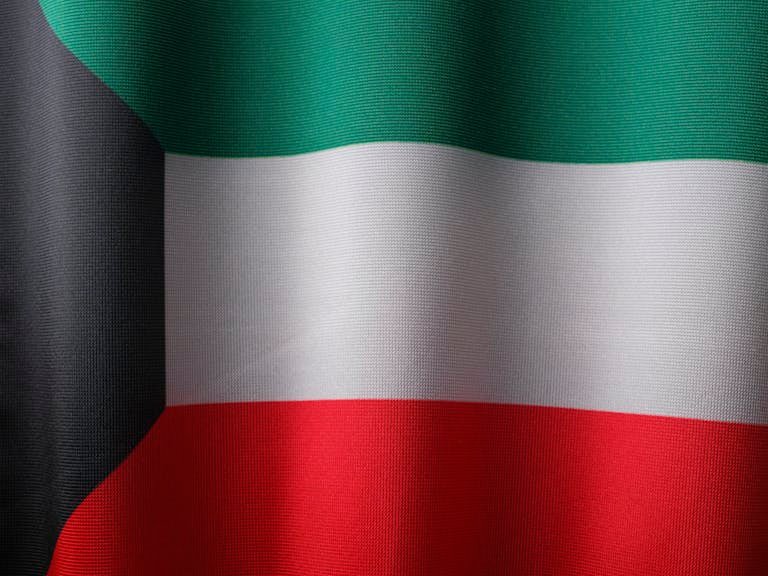 A detailed close-up of Kuwait's national flag with vibrant colors and gentle waves, symbolizing patriotism.