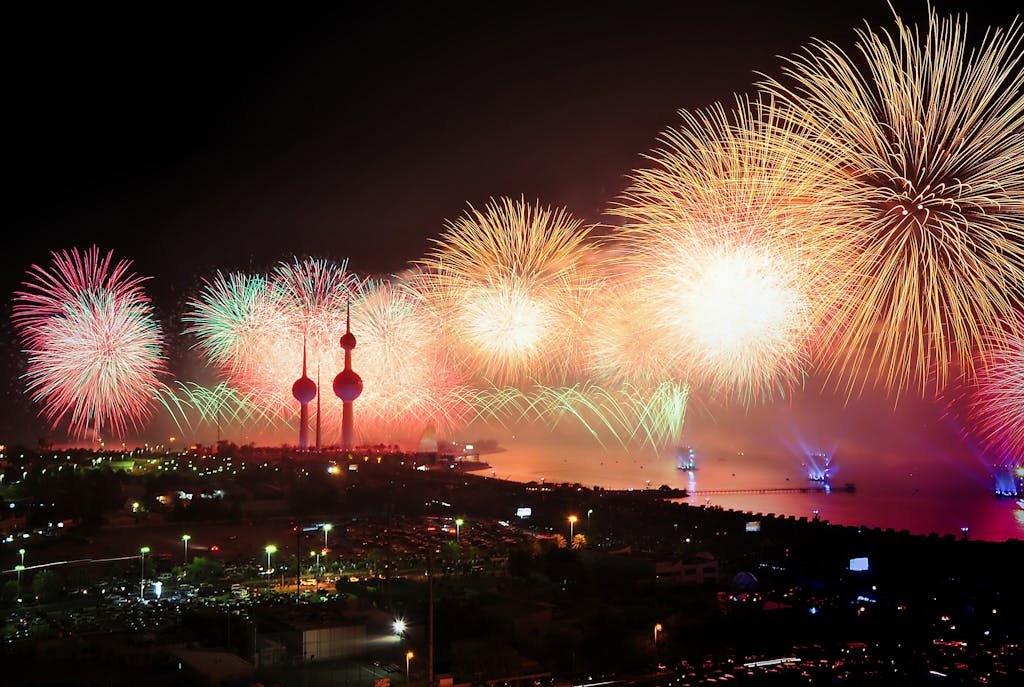 Colorful fireworks illuminate kuwait towers celebrating a night of joy and festivities